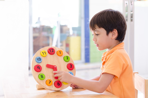 Child Holding a Clock