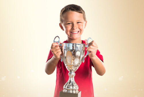 Kid Holding a Throphy