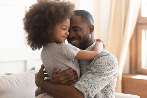 child and dad hugging